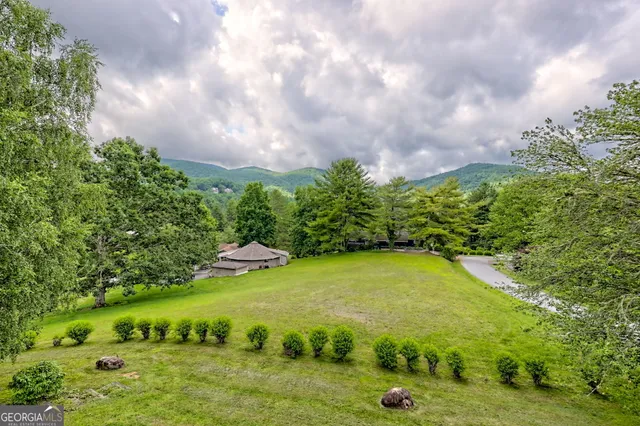 a kitchen with stainless steel appliances granite countertop a sink a stove and a wooden floors
