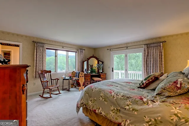 a spacious bedroom with two beds and painting on the wall