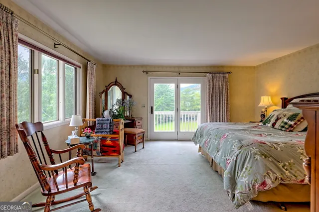 a living room with furniture fireplace and a large window