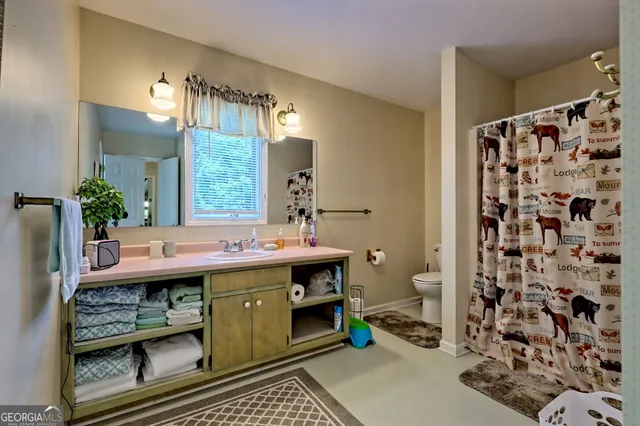 a front view of a house with a yard and plant