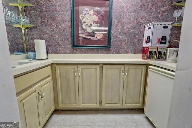 a view of a house with a big yard and large trees