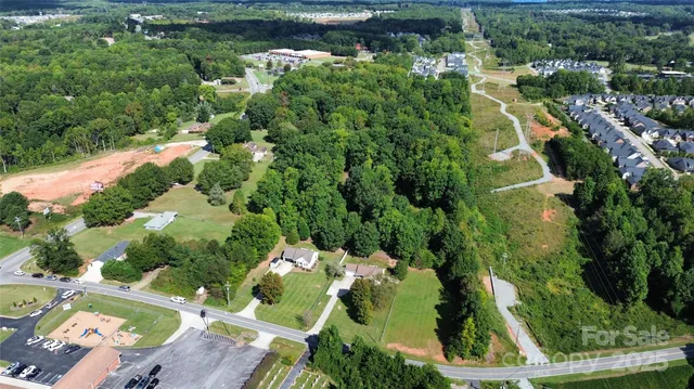 an aerial view of a house with a yard and lake view
