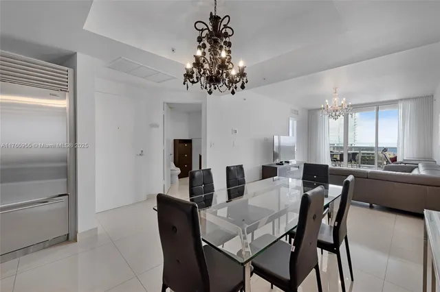 a view of a dining room with furniture and chandelier