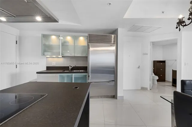 a kitchen with stainless steel appliances granite countertop a refrigerator and a stove