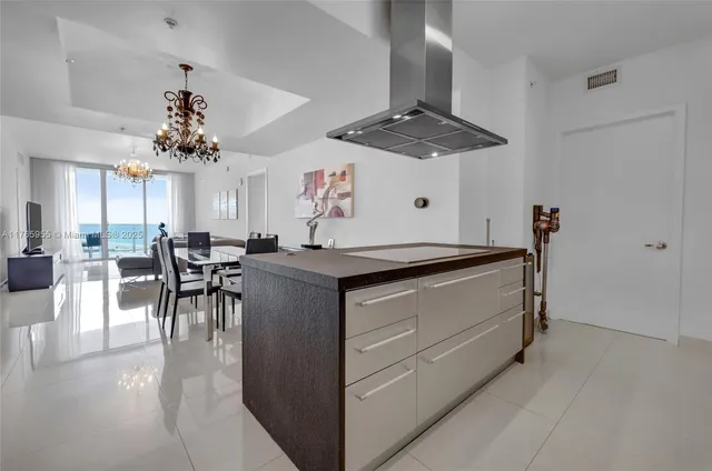 a kitchen with a chandelier furniture and a chandelier