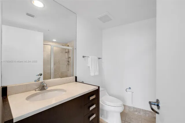 a bathroom with a sink a toilet a mirror and vanity