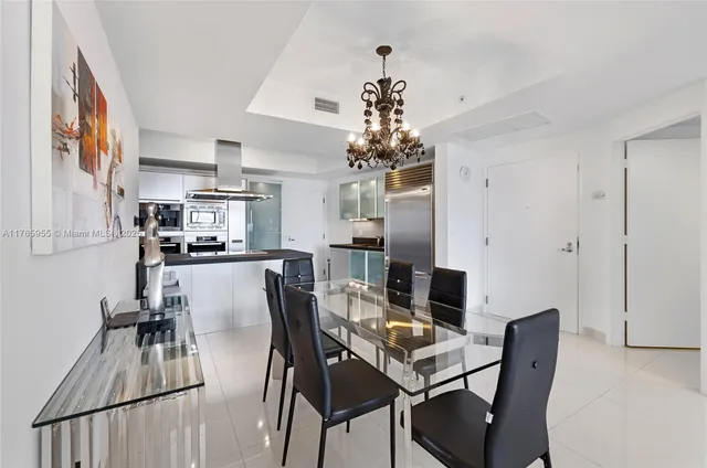 a view of a dining room with furniture and chandelier