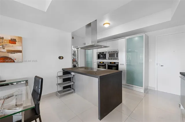 a kitchen with cabinets and chairs