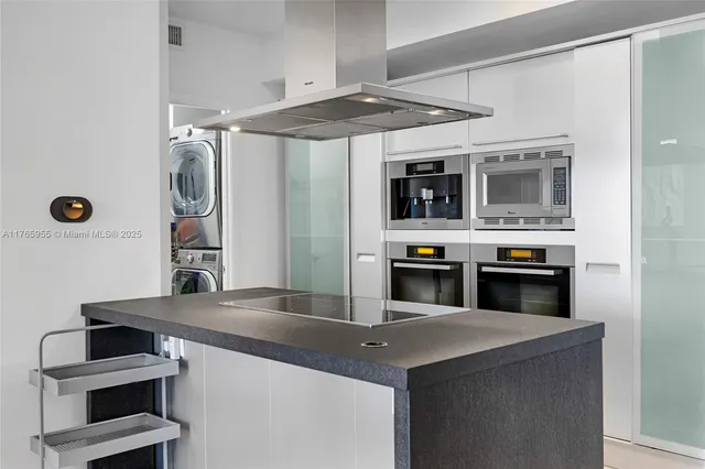 a kitchen with a sink and a stove top oven