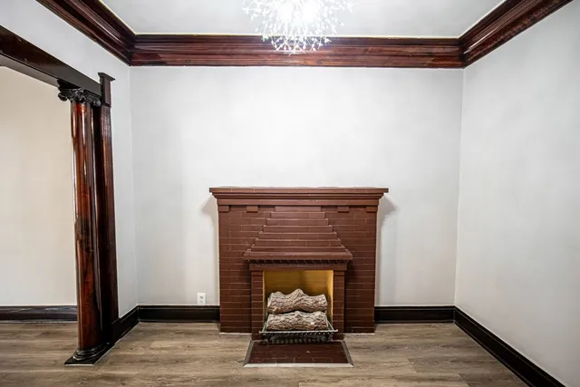 a living room with a fireplace and a rug