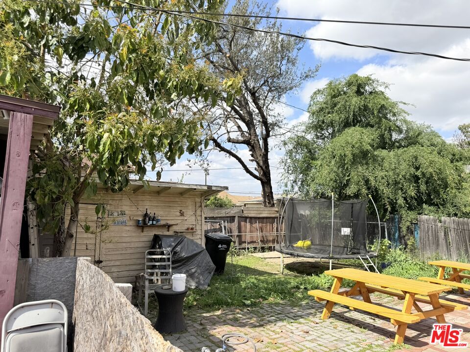 12918 Shreve Road Whittier, CA 90602 - Photo 8 of 42 a backyard of a house with barbeque oven table and chairs