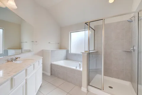 a white bath tub sitting next to a white sink