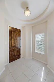 a view of an empty room with window and closet area