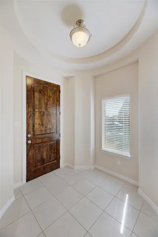 a view of an empty room with window and closet area