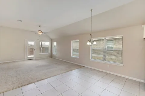 a view of a room with window and ceiling fan
