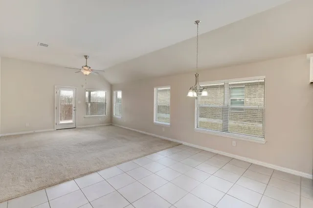 a view of a room with window and ceiling fan