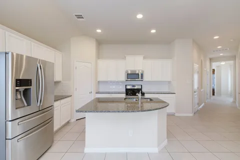 a kitchen with white cabinets stainless steel appliances and sink