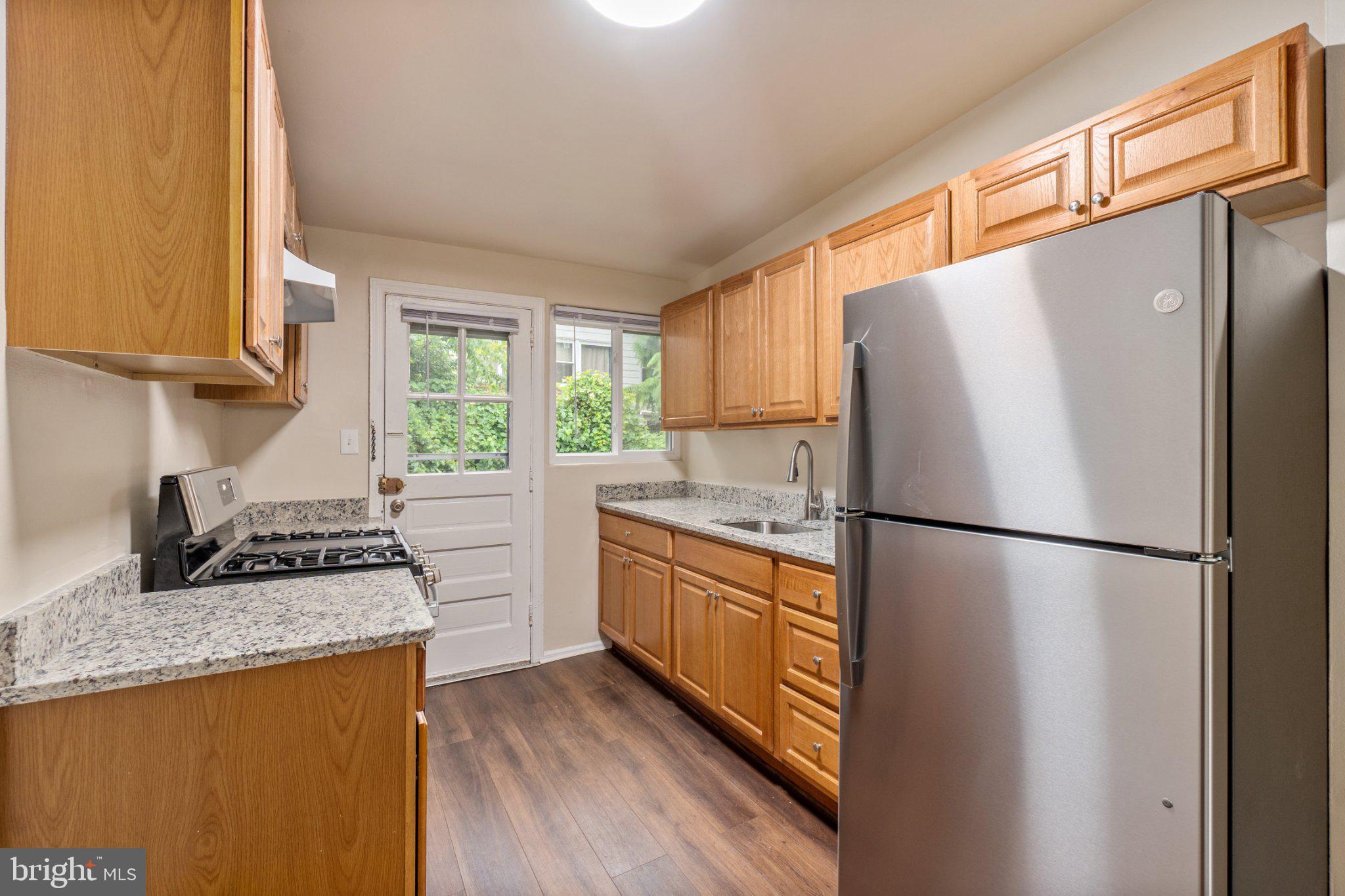 1029 Quebec Terrace, Unit 8 Silver Spring, MD 20903 - Photo 6 of 21 Modern kitchen with warm wood tones.