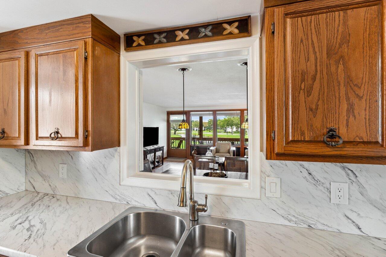 19867 Boca W Drive, Unit 3262 Boca Raton, FL 33434 - Photo 11 of 36 a kitchen with a sink and a window