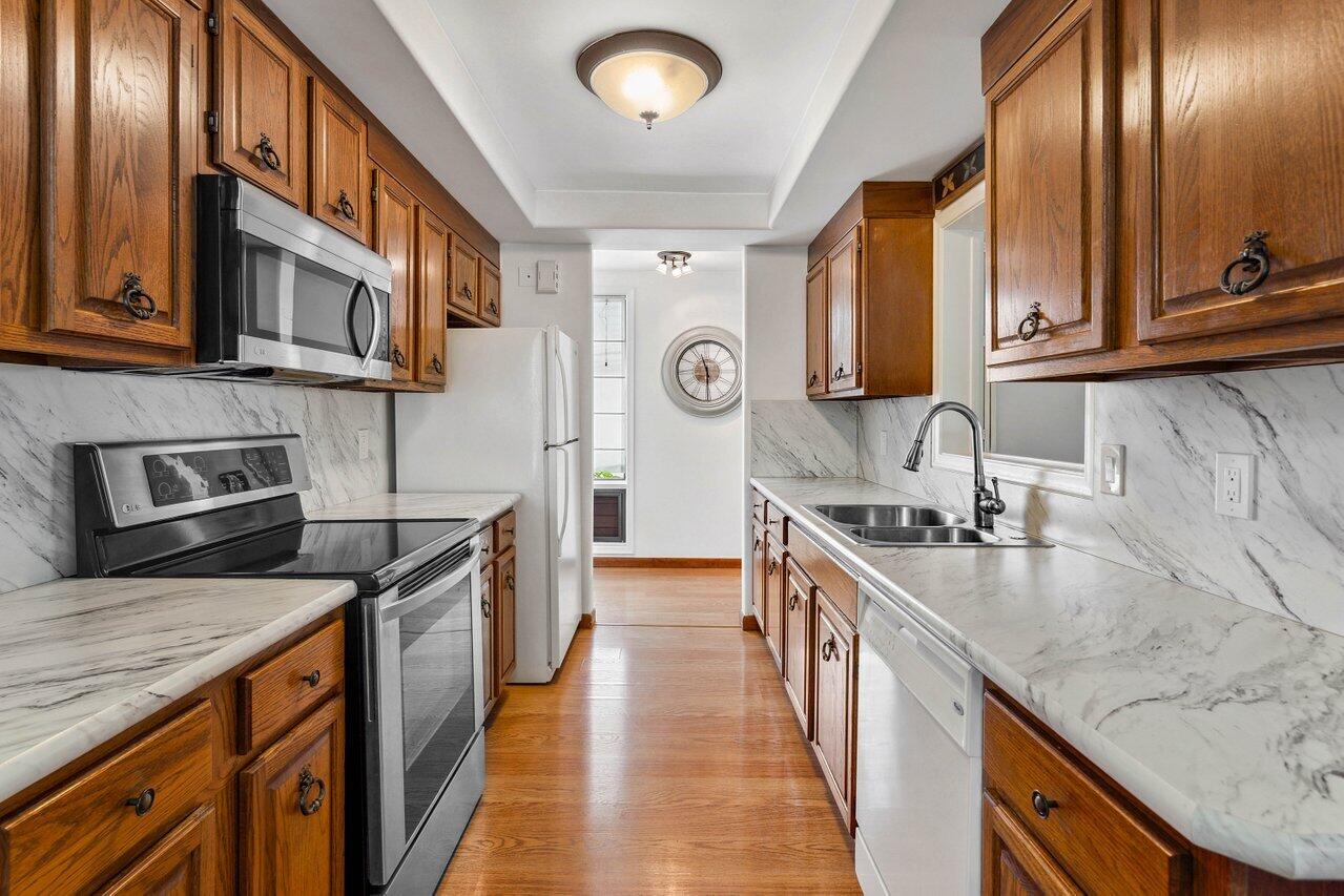 19867 Boca W Drive, Unit 3262 Boca Raton, FL 33434 - Photo 12 of 36 a kitchen with stainless steel appliances granite countertop a sink stove and cabinets