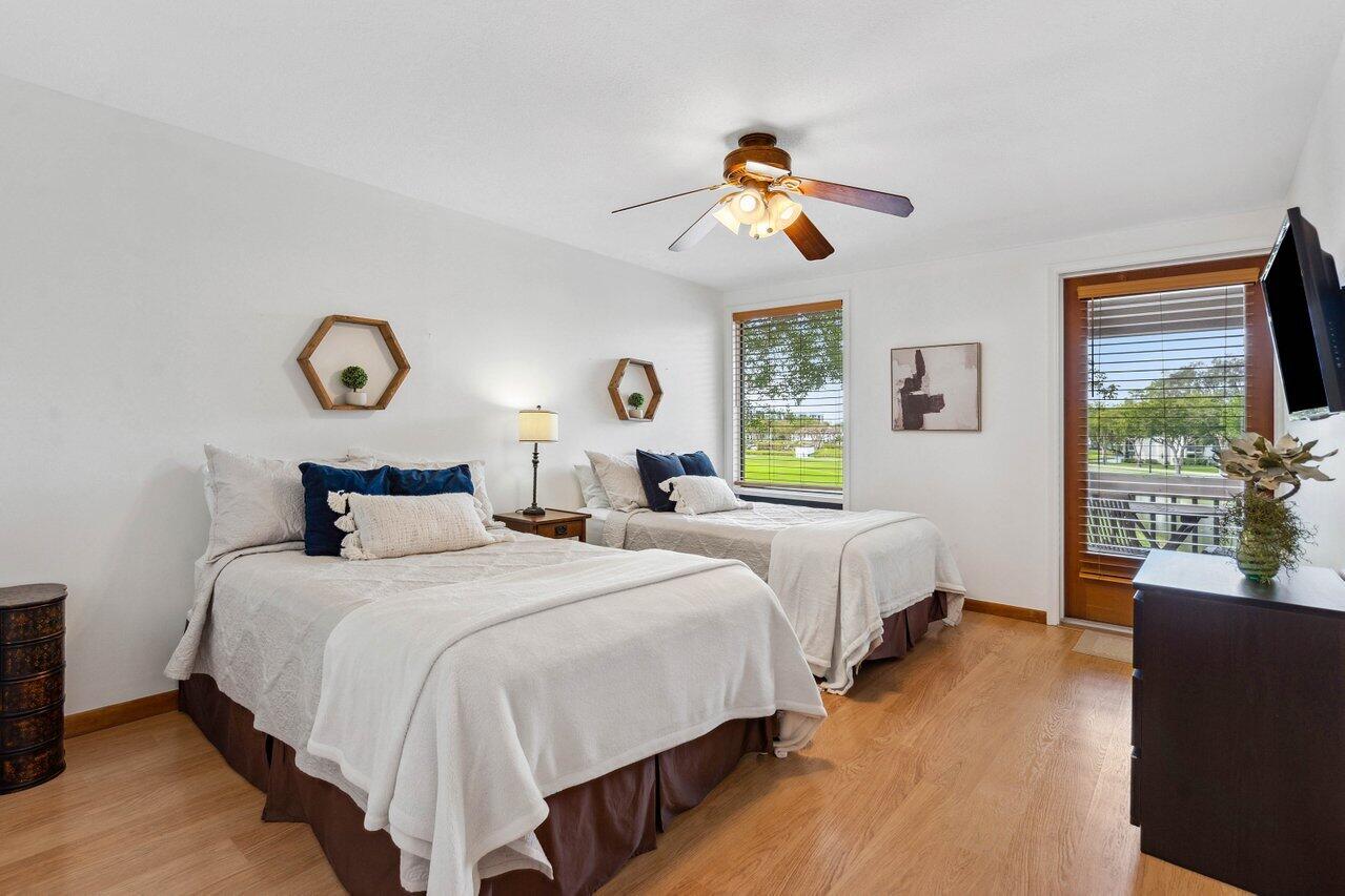 19867 Boca W Drive, Unit 3262 Boca Raton, FL 33434 - Photo 14 of 36 a bedroom with bed and a large window