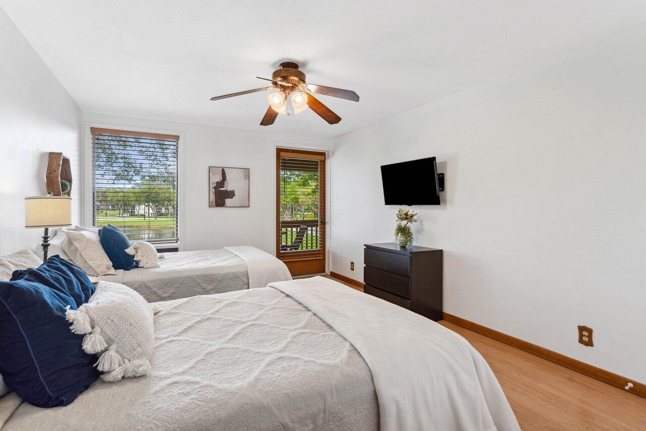 19867 Boca W Drive, Unit 3262 Boca Raton, FL 33434 - Photo 15 of 36 a bedroom with a bed and a flat screen tv