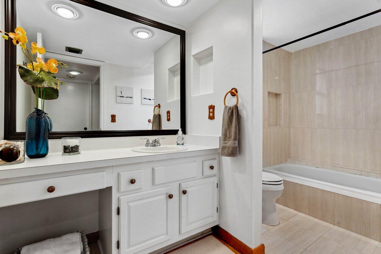 19867 Boca W Drive, Unit 3262 Boca Raton, FL 33434 - Photo 16 of 36 a bathroom with a sink vanity granite tub shower and a mirror