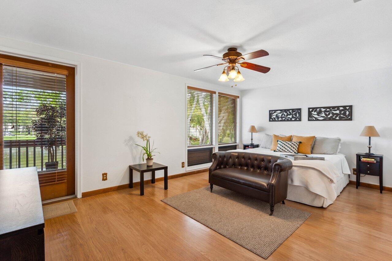 19867 Boca W Drive, Unit 3262 Boca Raton, FL 33434 - Photo 18 of 36 a spacious bedroom with a bed and a couch