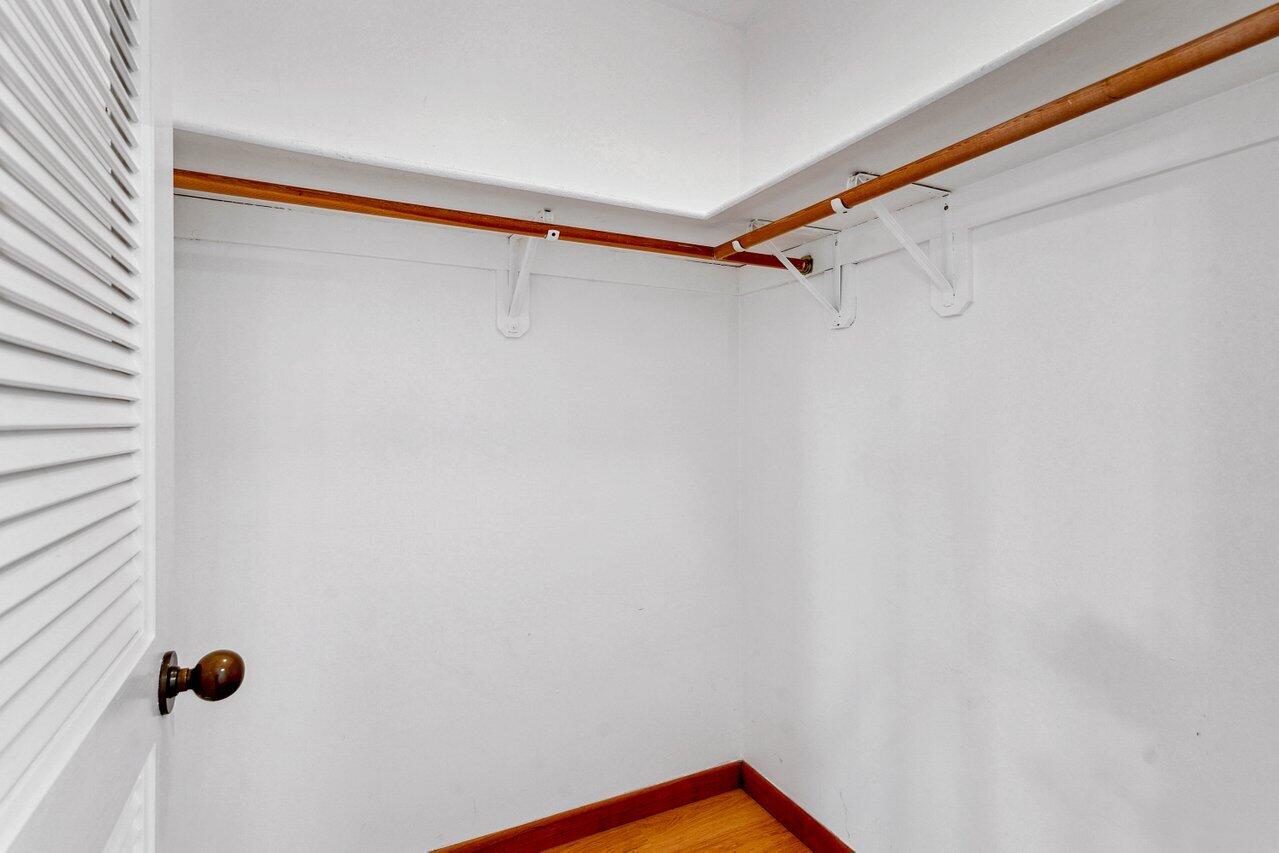 19867 Boca W Drive, Unit 3262 Boca Raton, FL 33434 - Photo 23 of 36 a view of walk in closet with clothes