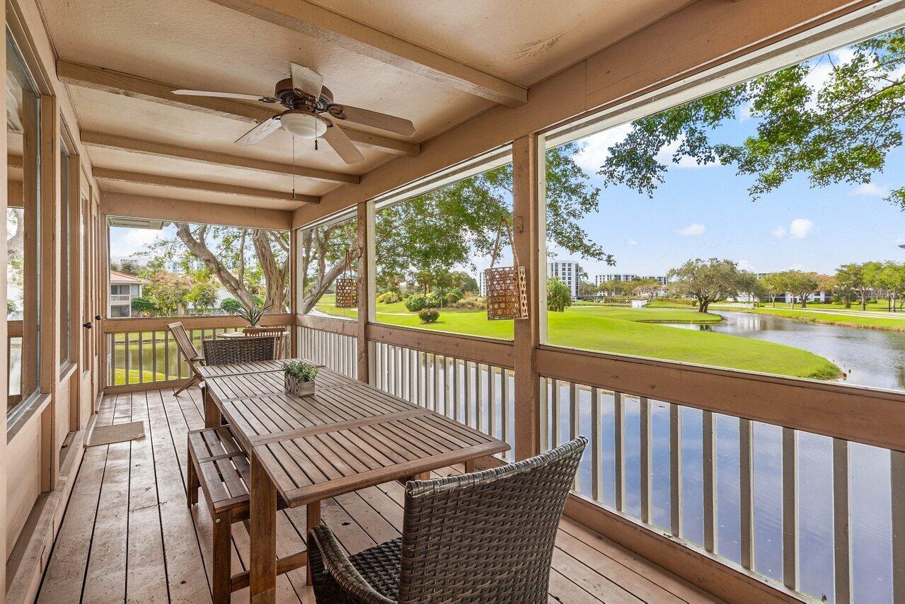 19867 Boca W Drive, Unit 3262 Boca Raton, FL 33434 - Photo 26 of 36 a view of a balcony with lake view and wooden floor