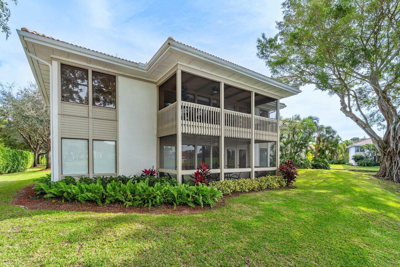 19867 Boca W Drive, Unit 3262 Boca Raton, FL 33434 - Photo 28 of 36 front view of a house with a yard