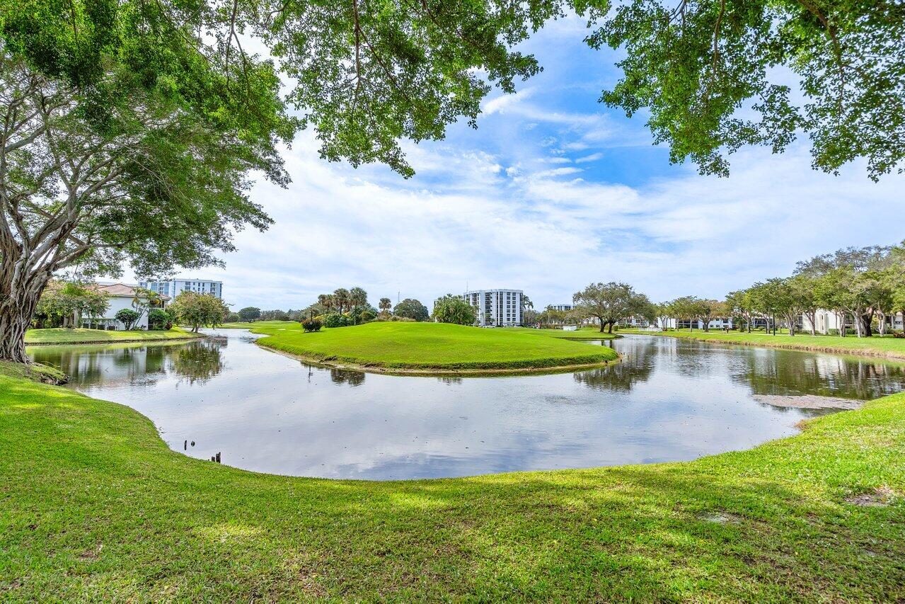 19867 Boca W Drive, Unit 3262 Boca Raton, FL 33434 - Photo 29 of 36 a view of a lake with houses in the back