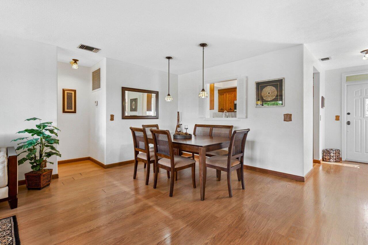 19867 Boca W Drive, Unit 3262 Boca Raton, FL 33434 - Photo 3 of 36 a view of a dining room with furniture window and wooden floor