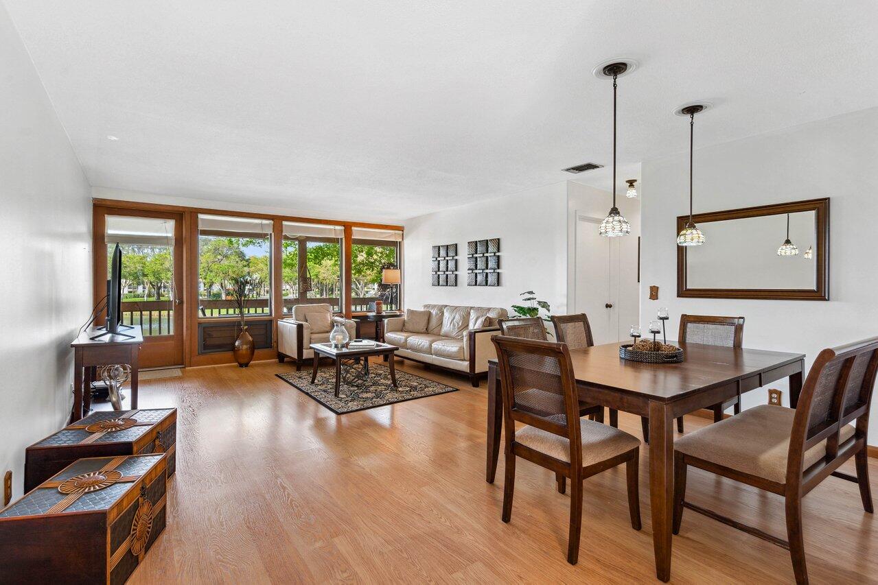 19867 Boca W Drive, Unit 3262 Boca Raton, FL 33434 - Photo 4 of 36 a living room with furniture and wooden floor