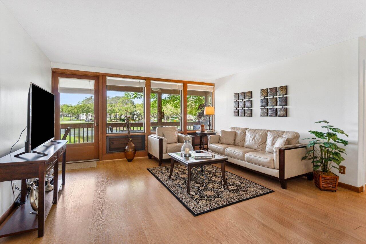 19867 Boca W Drive, Unit 3262 Boca Raton, FL 33434 - Photo 5 of 36 a living room with furniture and a flat screen tv