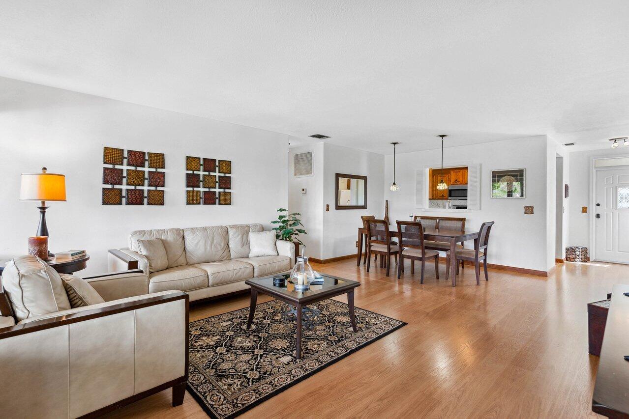 19867 Boca W Drive, Unit 3262 Boca Raton, FL 33434 - Photo 6 of 36 a living room with furniture and wooden floor