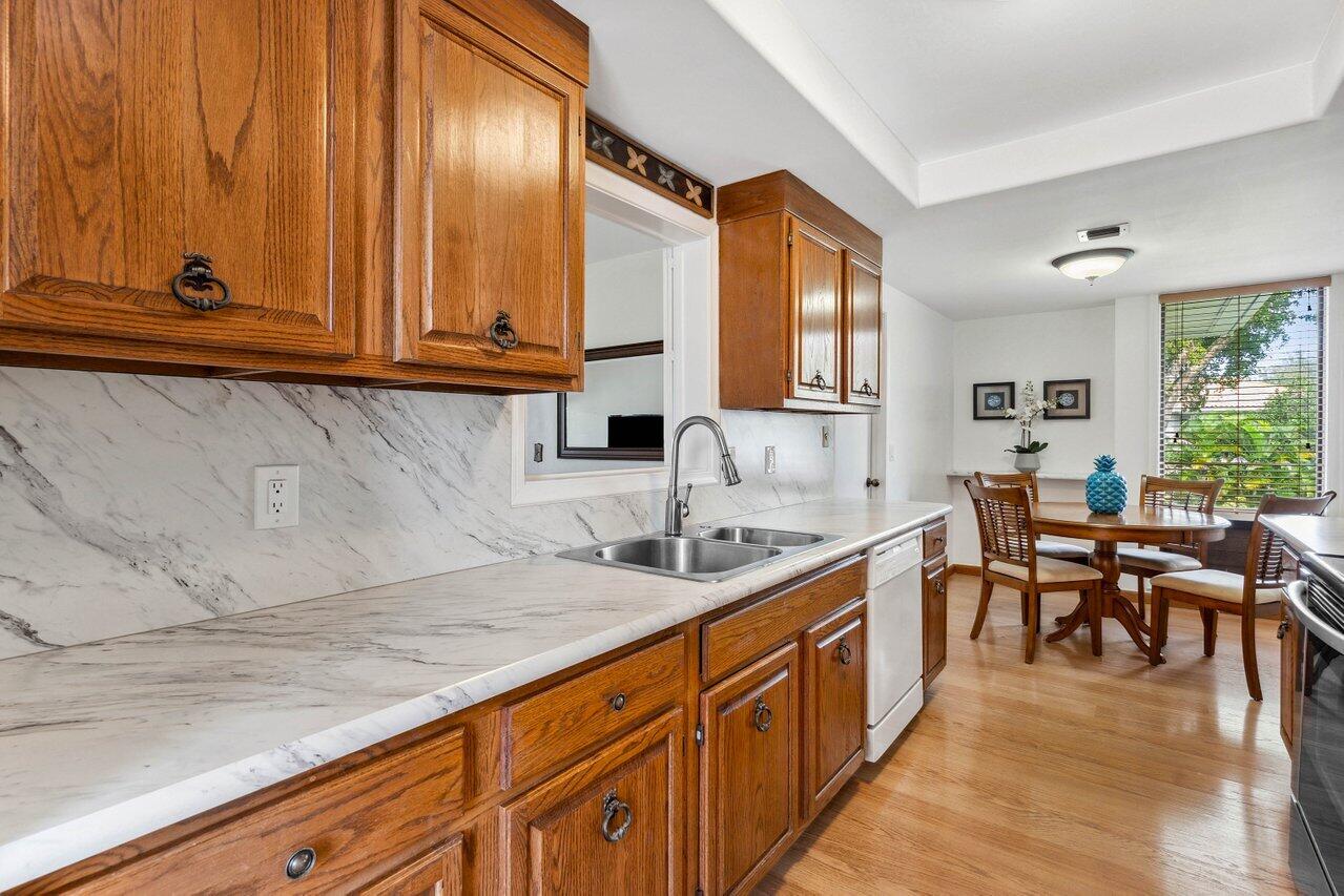 19867 Boca W Drive, Unit 3262 Boca Raton, FL 33434 - Photo 8 of 36 a kitchen with stainless steel appliances granite countertop wooden cabinets a sink and dishwasher