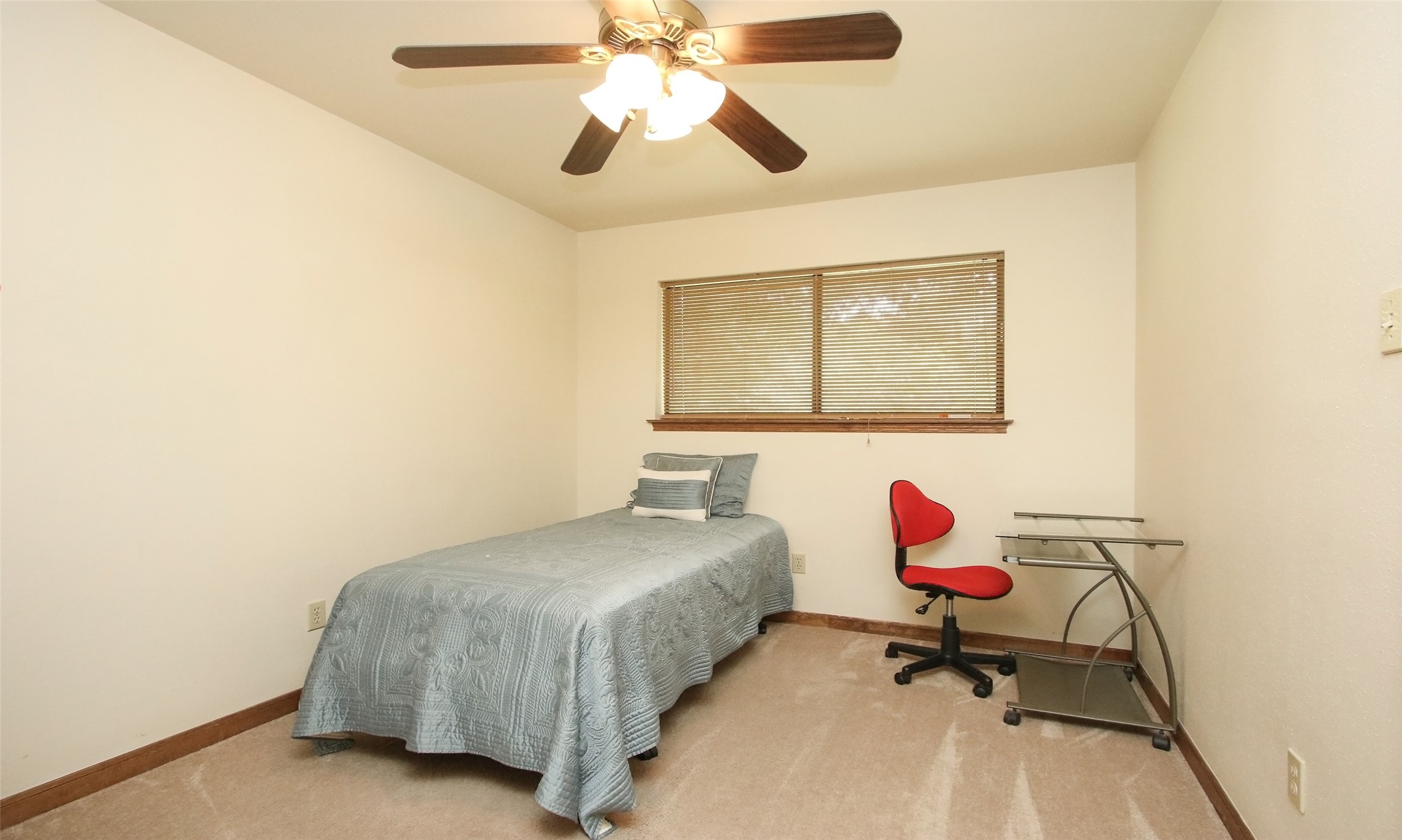 17406 Bobcat Trail Cypress, TX 77429 - Photo 18 of 28 a bedroom with a bed and a chandelier