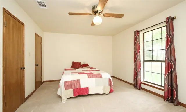 a bedroom with a bed and a window