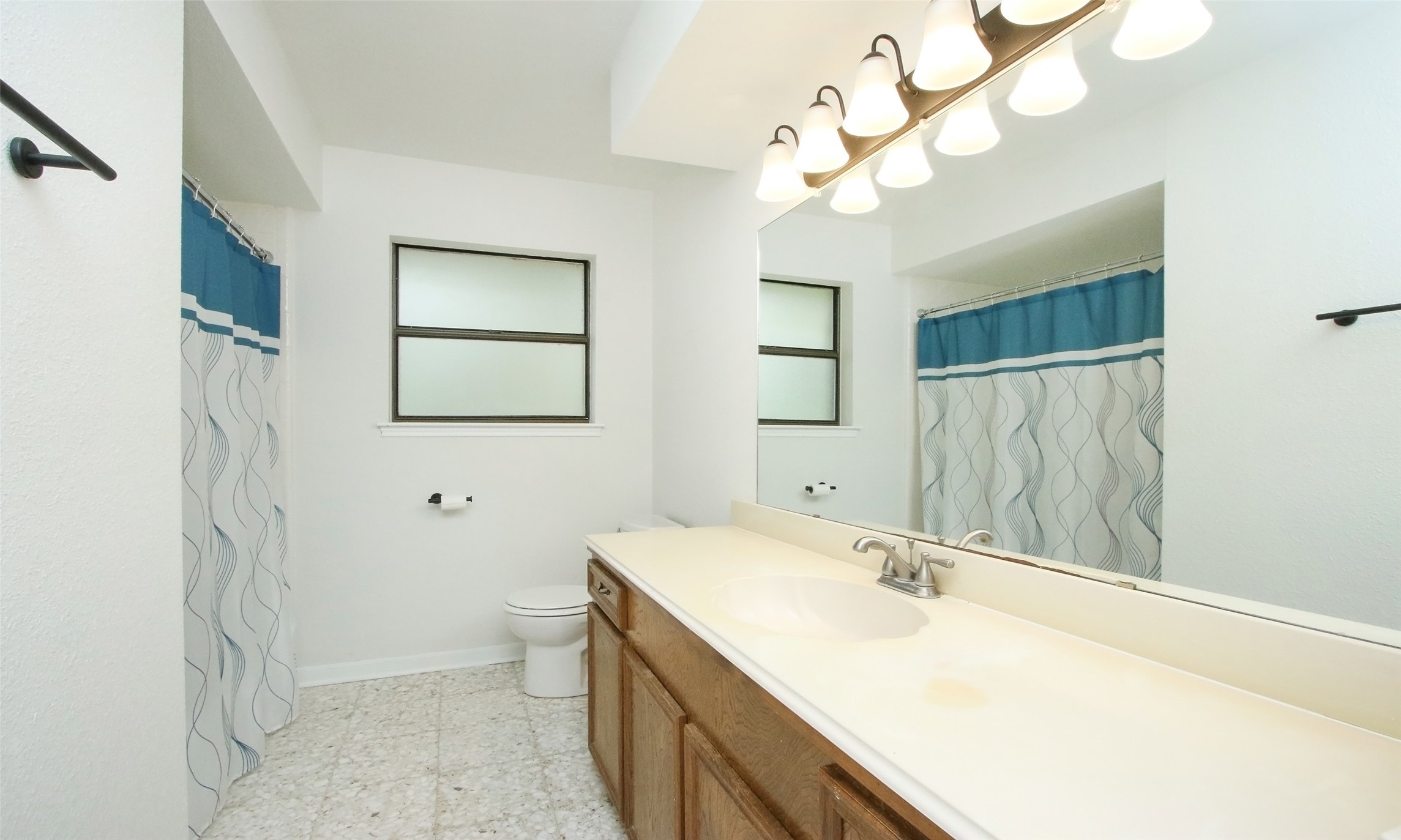 17406 Bobcat Trail Cypress, TX 77429 - Photo 20 of 28 a bathroom with a sink a toilet and a mirror
