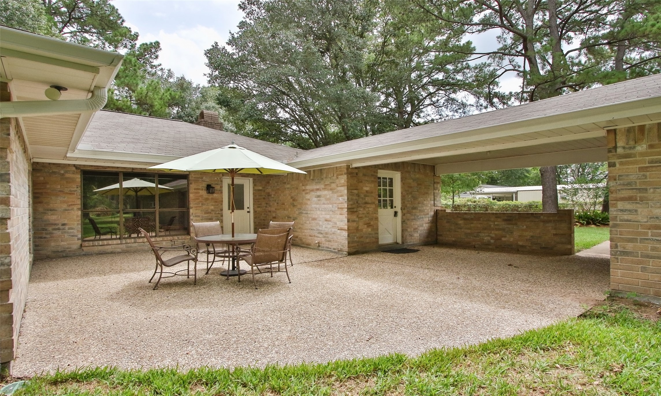 17406 Bobcat Trail Cypress, TX 77429 - Photo 21 of 28 a view of a patio with table and chairs under an umbrella