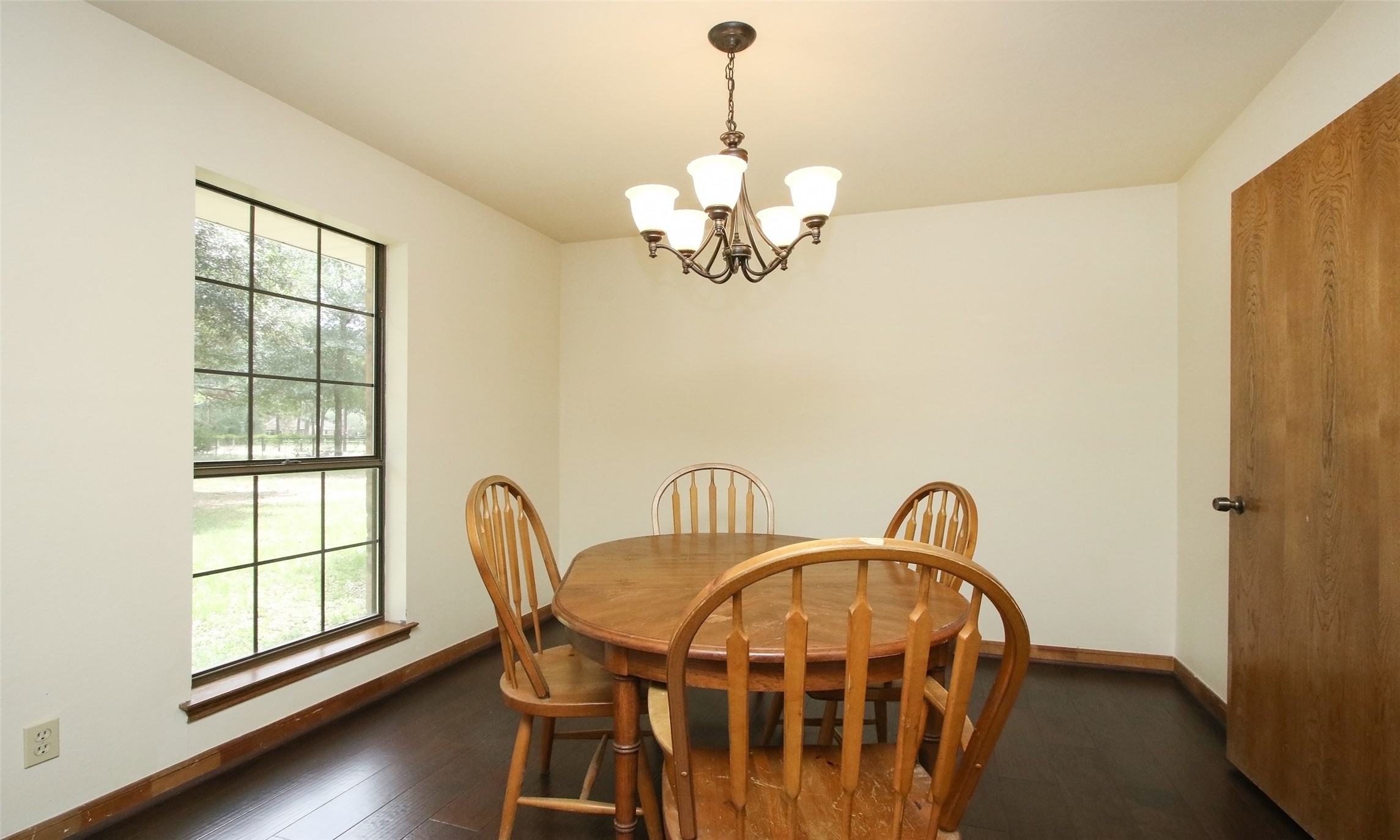 17406 Bobcat Trail Cypress, TX 77429 - Photo 8 of 32 a dining room with furniture a window and wooden floor