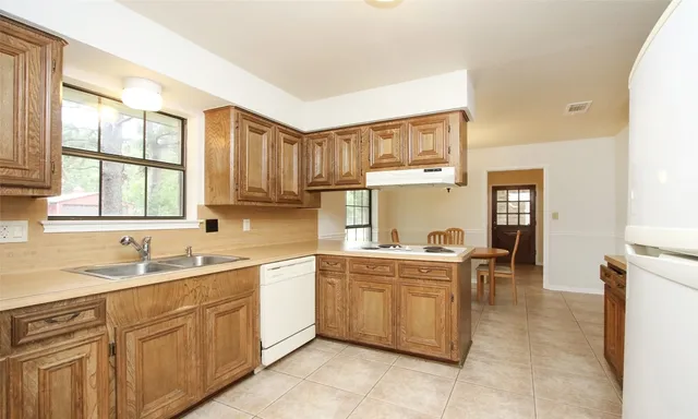 a kitchen with a sink stove and cabinets