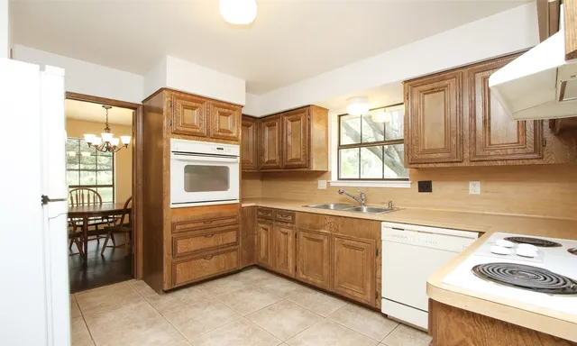 a kitchen with stainless steel appliances a stove sink and cabinets