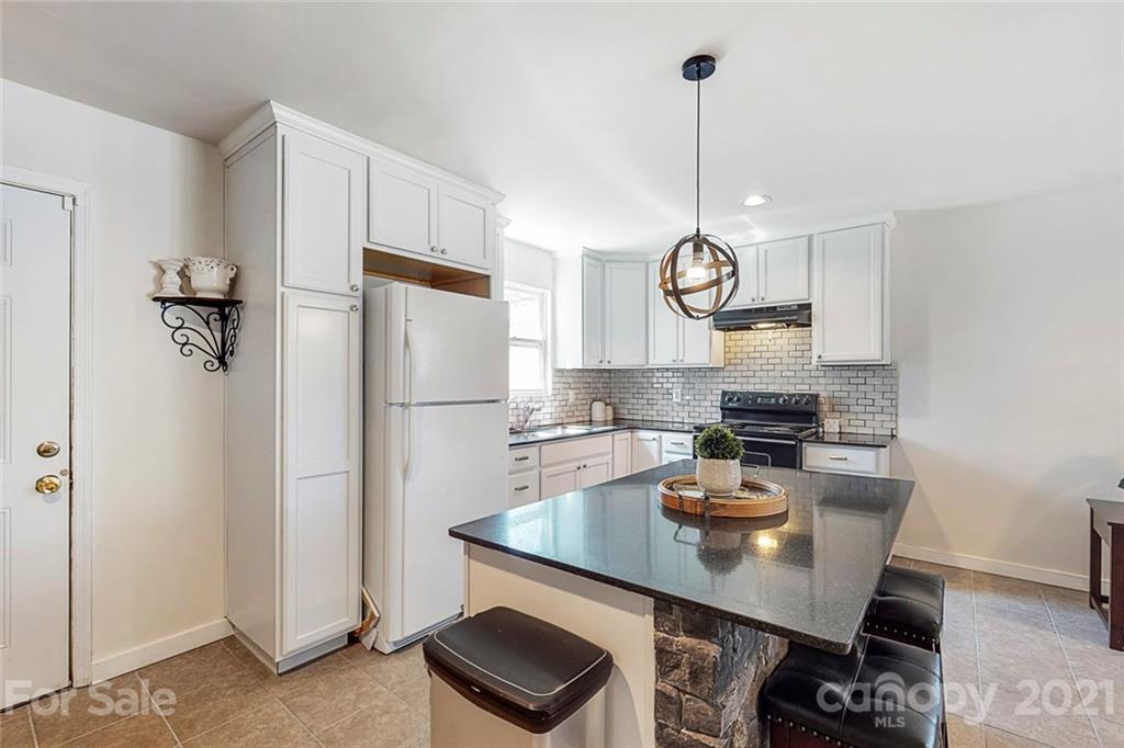 612 Ginger Cake Road Lancaster, SC 29720 - Photo 12 of 35 a kitchen with refrigerator a sink and chairs