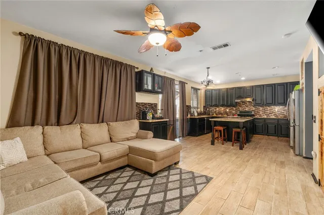 a living room with furniture and kitchen view