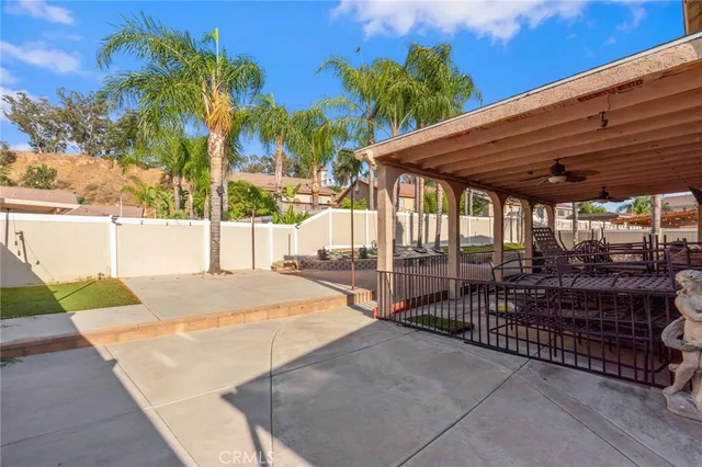 a view of a house with backyard and sitting area