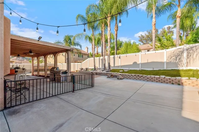 a view of a patio with table and chairs and potted plants