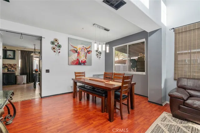 a view of a livingroom with furniture window and wooden floor