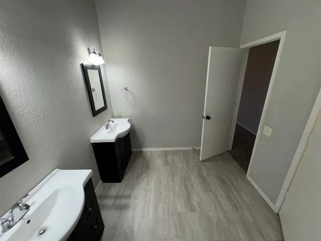 a bathroom with sink a toilet a mirror and vanity